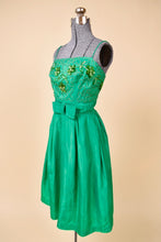 Load image into Gallery viewer, Vintage sixties green acetate embellished bust dress is shown in close up. This dress has a straight neckline with thin spaghetti straps. 
