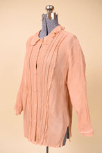 Load image into Gallery viewer, Vintage peach frilly button down top is shown from the front. This lacy shirt has a lace peter pan collar. 
