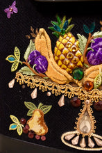 Load image into Gallery viewer, Vintage Enid Collins embroidered leather, canvas, and wood purse is shown in close up. This bag has a gold embroidered bedazzled fruit platter. 
