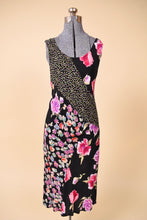 Load image into Gallery viewer, Vintage 1990&#39;s black floral print rayon midi dress is shown from the front. This dress has a scoop neckl. 

