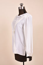 Load image into Gallery viewer, Vintage ivory white long sleeve blouse is shown from the side. 
