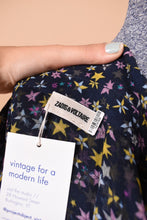 Load image into Gallery viewer, Designer sheer navy dress with yellow star print is shown in close up. This dress has a tag that reads Zadig and Voltaire.
