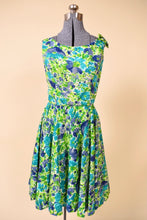 Load image into Gallery viewer, Vintage 1960&#39;s blue and green painterly floral day dress by Jay Herbert is shown from the front. This dress has a cute bow detail at the shoulder.
