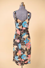 Load image into Gallery viewer, Vintage nineties multicolor floral print dress by Loco Lindo is shown from the back. This floral print ruffled midi dress has black flowers. 

