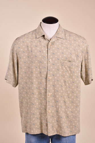 Vintage beige silk printed shirt by Nat Nast is shown from the front. This men's button down silk shirt has short sleeves. 