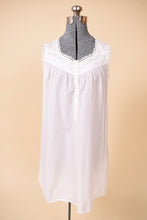 Load image into Gallery viewer, Vintage white cotton embroidered floral pajama dress is shown from the front. This dress is sleeveless with lace trim. 
