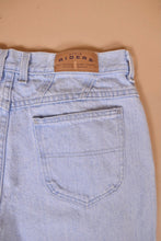 Load image into Gallery viewer, Vintage light blue nineties Riders mom jeans are shown in close up. These jeans have a yoke at the back.
