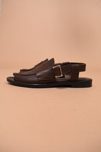 Load image into Gallery viewer, Brown Italian-made designer leather sandals are shown from the side. These sandals are flat and have a silver buckle.
