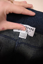 Load image into Gallery viewer, Vintage designer navy bell bottom stretch jeans are shown in close up. These St John Couture jeans are tagged a size 4. 
