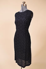 Load image into Gallery viewer, Vintage 50s black eyelet dress by Puritan is shown from the side. This dress is made from a sheer eyelet black cotton lace. 
