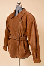 Load image into Gallery viewer, Vintage 80s brown suede jacket with a pointed collar is shown from the front. This jacket has a belt at the waist. 

