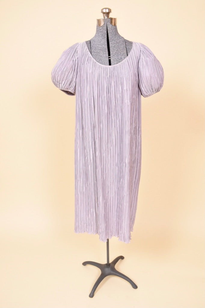 Vintage purple puff sleeve dress by Pierre Labiche is shown from the front. This dress has a rounded scoop neckline. 