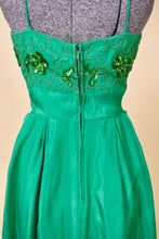 Load image into Gallery viewer, Vintage sixties green mini party dress is shown in close up. This dress has a metal zipper down the back. 
