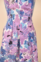 Load image into Gallery viewer, Vintage 50&#39;s girly purple painted floral print day dress is shown in close up. This dress has pleats down the bodice. 
