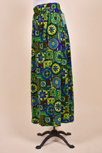 Load image into Gallery viewer, Vintage cool tone green, yellow, and blue geometric print maxi skirt is shown from the side. This skirt is by the brand Dutchmaid.
