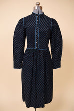 Load image into Gallery viewer, Vintage 70s Lanz black and blue calico floral print midi dress is shown from the front. This dress has silver buttons down the front of the bust. 
