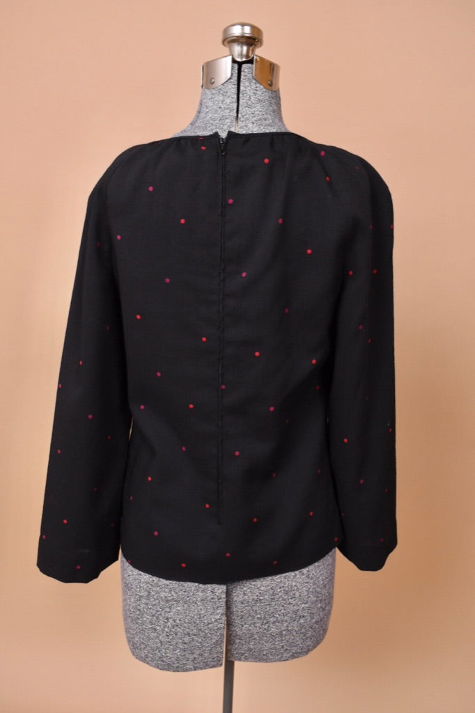 The top is facing backward on the mannequin. There is a back zipper.
