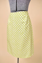 Load image into Gallery viewer, Vintage 2000&#39;s white and green checkerboard print is shown from the side. This high waisted mini pencil skirt is by the designer Gianni Versace. 
