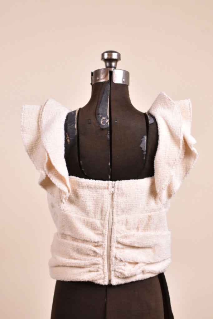 Vintage new with tags white terry cloth ruffle top by Koch is shown from the back. 
