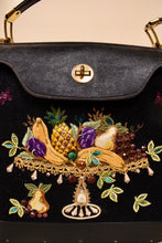 Load image into Gallery viewer, Vintage 60&#39;s black canvas and leather purse is shown in close up. This bag has a quirky embroidered fruit platter with big gems. 
