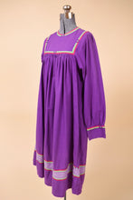 Load image into Gallery viewer, Vintage purple 1970&#39;s tunic dress is shown from the side. This dress has hot pink and green trim.
