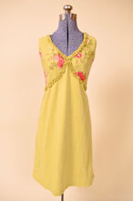 Load image into Gallery viewer, Vintage chartreuse green floral linen midi dress is shown from the front. This dress has a ruffle trim on the bust. 
