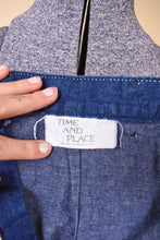 Load image into Gallery viewer, Vintage 1970s denim dark wash midi length skirt is shown in close up. This skirt has a tag that reads Time and Place. 
