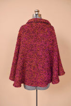 Load image into Gallery viewer, Vintage Irish wool pink and orange woven boucle cape is shown from the back. This cape has a turtleneck.
