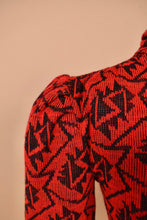 Load image into Gallery viewer, Vintage 80&#39;s midi length knit red bodycon dress is shown in close up. This dress has puff sleeves.
