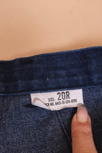 Load image into Gallery viewer, Vintage seventies dark wash denim flare jeans are shown in close up. These jeans are tagged a size 20R.
