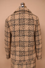 Load image into Gallery viewer, Vintage 60s tan and grey wool tweed skirt set is shown from the back. This skirt set has a blazer in a matching tweed. 
