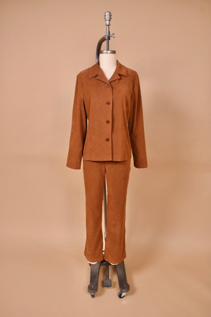 Vintage 1990's faux suede brown western inspired pantsuit is shown from the front. This two piece set has a blazer and bootcut pants.