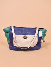 Load image into Gallery viewer, Vintage Y2K colorblock Carrie purse by Coach is shown from the front. This purse is made from a navy blue, green, and white leather. 
