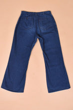 Load image into Gallery viewer, Vintage 70&#39;s navy flare jeans are shown from the back. These high waisted seventies jeans have two back pockets.
