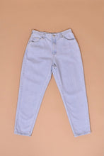 Load image into Gallery viewer, Vintage 1990&#39;s light blue denim mom jeans are shown from the front. These tapered light wash jeans are by Riders.

