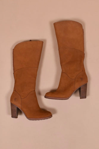 Vintage brown leather tall heeled boots by Timberland are shown from above. These boots have a stacked wooden heel. 