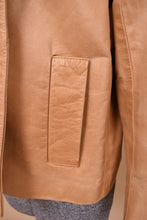 Load image into Gallery viewer, Vintage tan leather jacket by Cole Haan is shown in close up. This jacket is made from a soft beige leather. 
