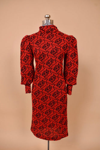Vintage red and black knit 1980's dress is shown from the front. This dress has puffed sleeves.