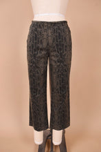 Load image into Gallery viewer, Vintage 1990s grey and black faux snakeskin cotton capris are shown from the front. These capri pants have a slightly flared fit. 
