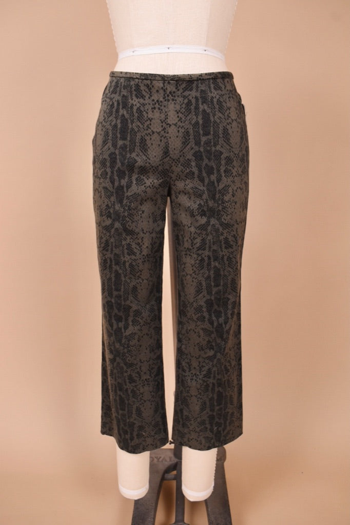 Vintage 1990s grey and black faux snakeskin cotton capris are shown from the front. These capri pants have a slightly flared fit. 