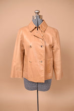 Load image into Gallery viewer, Vintage beige leather double breasted jacket by Cole Haan is shown from the front. This jacket has a foldover collar. 

