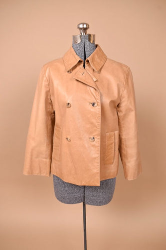 Vintage beige leather double breasted jacket by Cole Haan is shown from the front. This jacket has a foldover collar. 