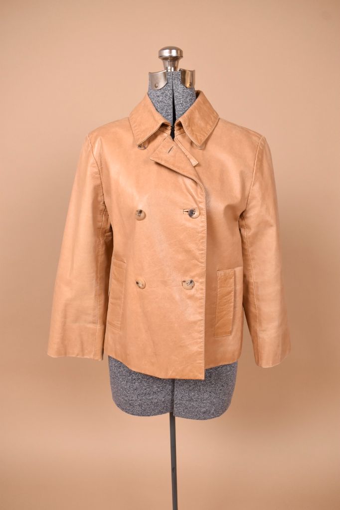 Vintage beige leather double breasted jacket by Cole Haan is shown from the front. This jacket has a foldover collar. 