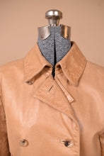 Load image into Gallery viewer, Vintage tan leather Cole Haan jacket is shown in close up. This jacket has tortoiseshell buttons on the front. 
