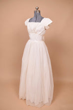 Load image into Gallery viewer, Vintage 50s poofy princess wedding dress is shown from the side. This dress is fitted at the bodice with a layered tulle skirt made from a polka dot mesh.
