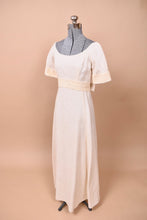 Load image into Gallery viewer, The dress is angled on the mannequin. A back bow is slightly visible.
