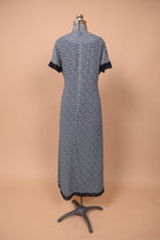 Load image into Gallery viewer, Vintage Laura Ashley silk chiffon maxi dress is shown from the back. This dress has a navy and white tiny floral print.
