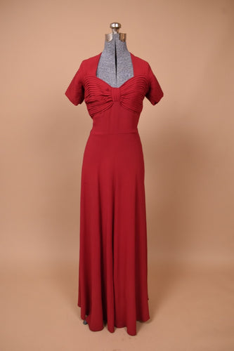 Vintage 1940s merlot red crepe gown is shown from the front. This dress has pleated sleeves.