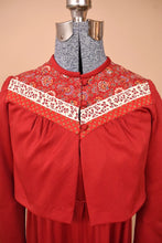 Load image into Gallery viewer, Vintage 70s red bolero jacket by Lanz is shown in close up. This jacket has a multicolor paisley print yoke.
