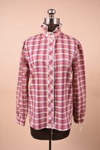 Load image into Gallery viewer, The top is facing forward on a mannequin. It is buttoned to the top. There is a high ruffle collar.
